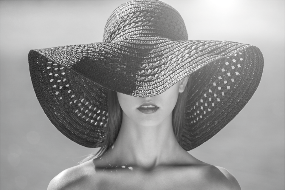 Woman with large straw hat covering her face